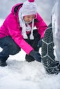 Woman putting winter chains on car Royalty Free Stock Photo