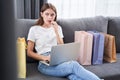 Woman puzzled while sitting at the sofa Royalty Free Stock Photo