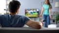 Woman quarreling, man watching football match, ignoring conflict, relationship Royalty Free Stock Photo