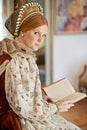 Woman, queen and book with portrait for renaissance, royalty aesthetic and reading in palace bedroom. Monarch, wealthy Royalty Free Stock Photo