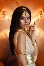 Woman queen Cleopatra art photo. Creative golden makeup Black hair braids. Carnival ethnic egypt costume dress