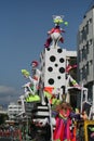 Woman in queen costume riding a float with carnival dolls