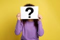 Woman with question mark sign on background Royalty Free Stock Photo