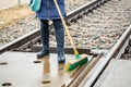 Woman railway employee clean with brush