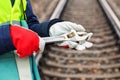 Woman railway employee holding adjustable wrenches