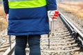 Woman railway employee with wrenches on railway