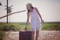 Woman on a railway retro style with a suitcase