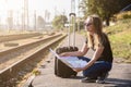 Woman on railway station searching in map for next destination Royalty Free Stock Photo