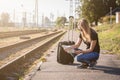 Woman on railway station searching in map for next destination Royalty Free Stock Photo