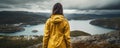 woman in rain jacket by lake in the mountains AI generated Royalty Free Stock Photo