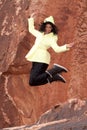 Woman in raincoat jumping