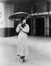 Woman in a raincoat and umbrella