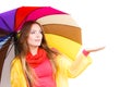 Woman in rainproof coat under umbrella