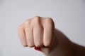 Woman raised fist, or the clenched fist,  isolated on white background Royalty Free Stock Photo