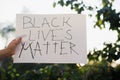 Woman raised hands showing sign black lives matter