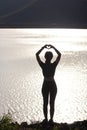 woman raised her hands and made heart symbol to express meaning of love friendship and kindness to her friends and lovers. woman