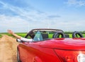 A woman raises her hands in a car in nature. Royalty Free Stock Photo