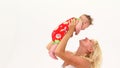 A woman raises a happy baby over her head.