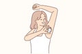 Woman raising hand using deodorant during morning hygiene routine to avoid sweat and odor