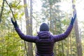 Woman raising her hands as embraces a nature