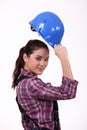 Woman raising her hard hat Royalty Free Stock Photo