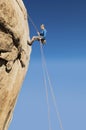 Woman Rappelling From Cliff Royalty Free Stock Photo