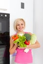 Woman raw fresh vegetables refrigerator