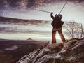 Woman reached mount peak. Girl wears backpack and sunglasses