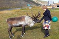 Woman reaches out her hand to deer