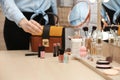 Woman reaching for cosmetic products on dressing table, closeup. Royalty Free Stock Photo