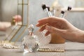 Woman reaching for crystal bottle of luxurious perfume Royalty Free Stock Photo