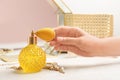 Woman reaching for crystal bottle of luxurious perfume Royalty Free Stock Photo