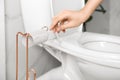 Woman reaching for empty toilet paper roll in bathroom Royalty Free Stock Photo