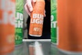A woman reaching in to refrigerator to get a cold Bud Light Orange. Royalty Free Stock Photo