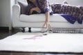 Woman Reaching Toward Spilled Wine Glass On Rug