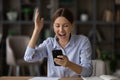 Woman read great news on cellphone scream with joy