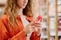 Woman read label on cosmetic bottle Royalty Free Stock Photo