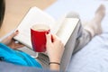 Woman reading a book in bed Royalty Free Stock Photo