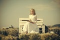 Woman reading book on bench on blue sky Royalty Free Stock Photo