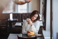 Woman reading book at cafe near window Royalty Free Stock Photo