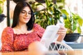 Young woman reading book at cafe near window Royalty Free Stock Photo