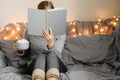 Woman reading book in cozy room