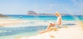 Woman reading book, enjoying sun on beach. Royalty Free Stock Photo