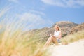 Woman reading book, enjoying sun on beach. Royalty Free Stock Photo