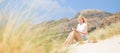 Woman reading book, enjoying sun on beach. Royalty Free Stock Photo