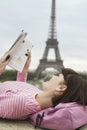 Woman Reading Book In Front Of Eiffel Tower