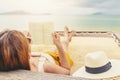 Woman reading a book on hammock beach in free time summer holiday Royalty Free Stock Photo