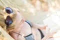 Woman reading book in hammock on the beach Royalty Free Stock Photo