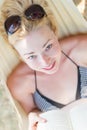 Woman reading book in hammock on the beach Royalty Free Stock Photo