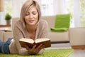 Woman reading book at home